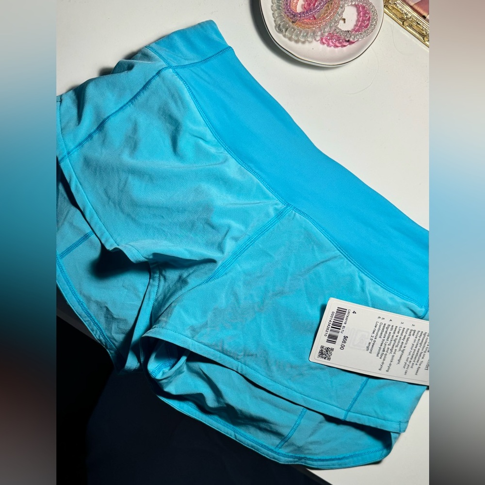 NWT electric turquoise 2.5” speed ups size 4